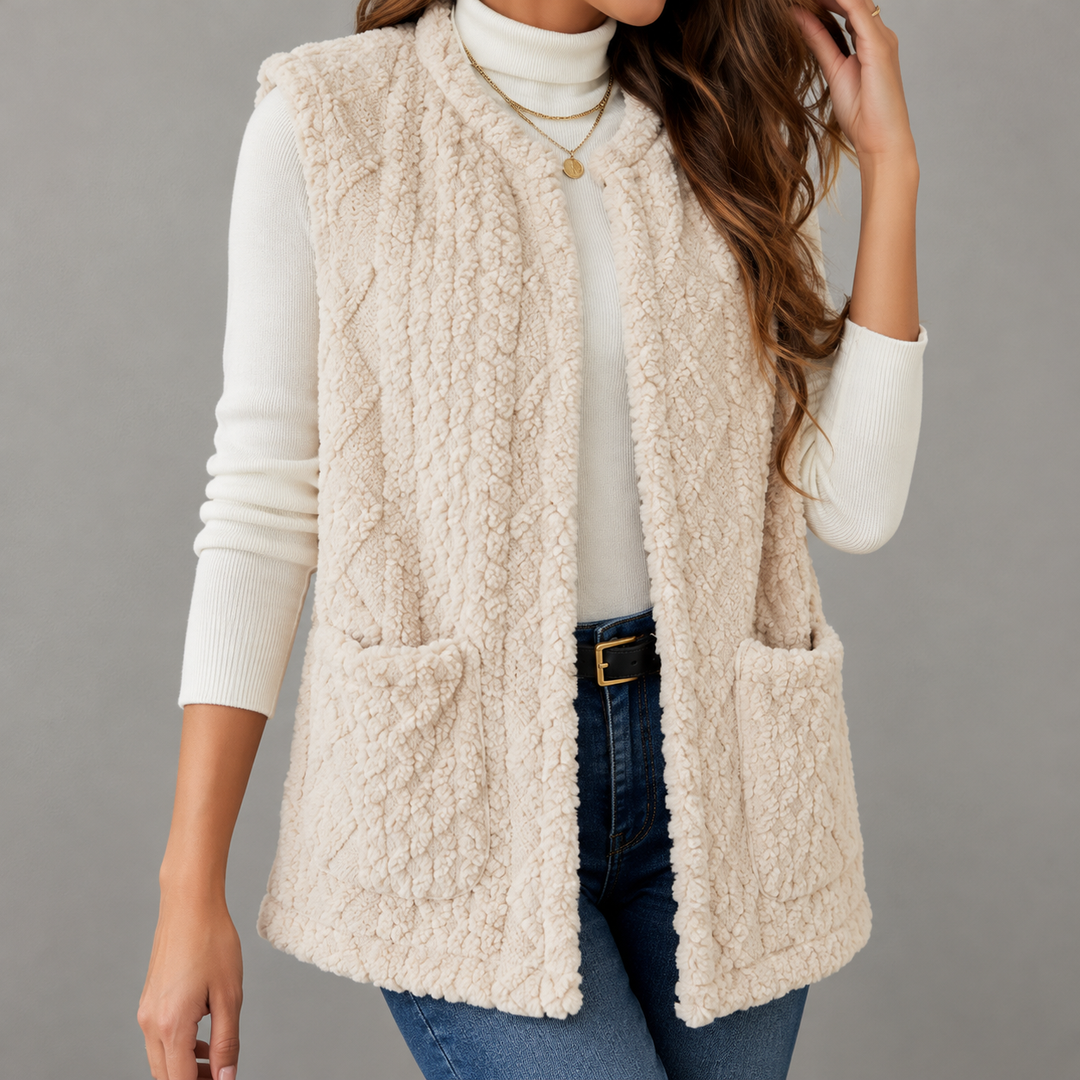 Sleeveless women's knitted vest with a cable-knit pattern and pockets