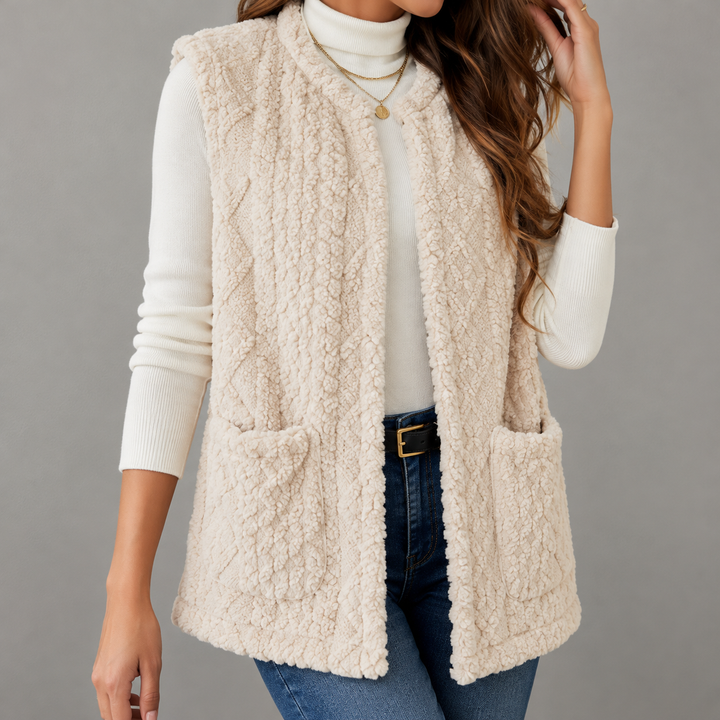 Sleeveless women's knitted vest with a cable-knit pattern and pockets