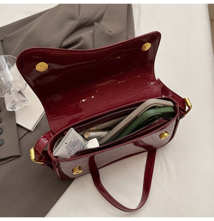 Tira | Glanzende Schoudertas met Golvend Design