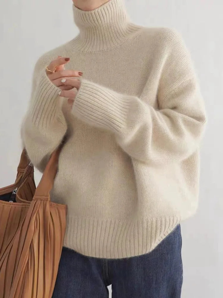 Genevieve oversized turtleneck sweater in cream, front view with tote bag